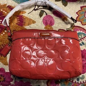 ORANGE COACH PAPAYA WRISTLET • EMBOSSED SIGNATURE C •